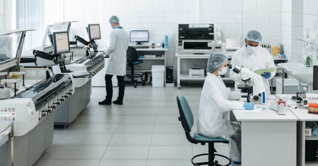 Researchers in lab coats performing experiments with advanced equipment in a laboratory.